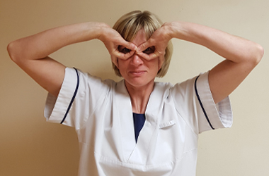 Both hands against the eyes, making a circle with the thumb and index finger