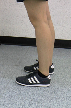 Standing, feet a stride away from a wall