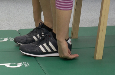Closeup of hands next to feet