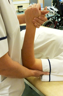 Hand is being held, arm bent and supported at the elbow
