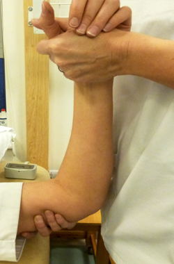 Hand is being held, bent at the elbow and supported - the arm has been taken further out so moving towards a right angle position