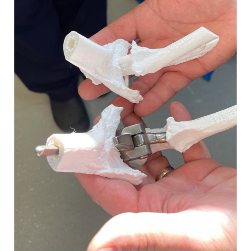 The finished 3D modelled joint and pin being held in someone's hand