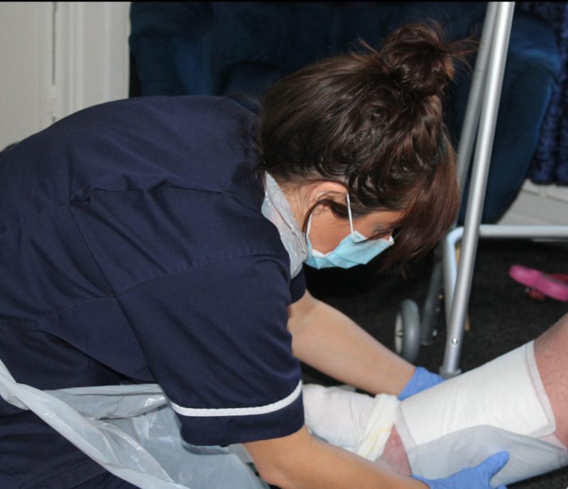 Rebecca changing a wound dressing 