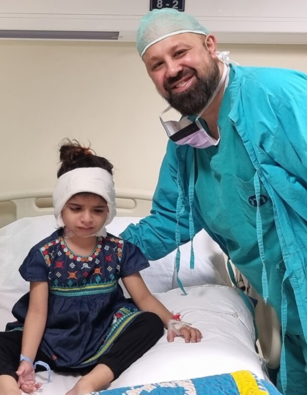 Mr Ahmad with the recipient of the world’s first free bilateral humanitarian cochlear implant