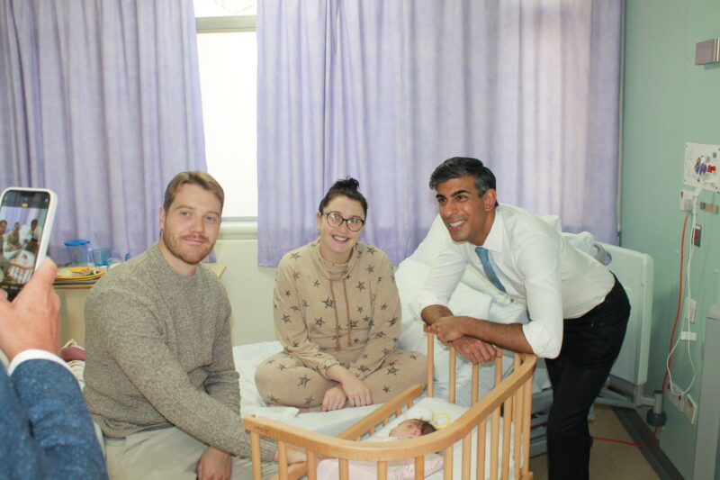 Rishi Sunak with parents Tim and Katie Smith-Burrow and their baby
