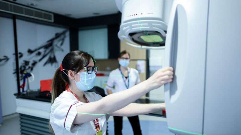 Staff with radiotherapy machine