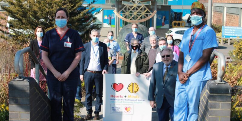 Clinical staff outside hospital entrance