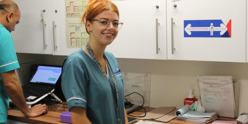 Hannah smiling at her desk