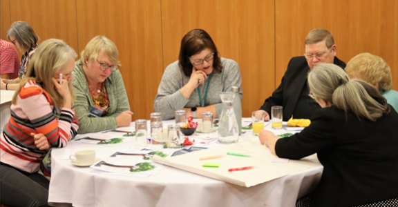 People sat around a table sharing ideas