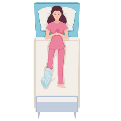 person with a broken leg laying in bed