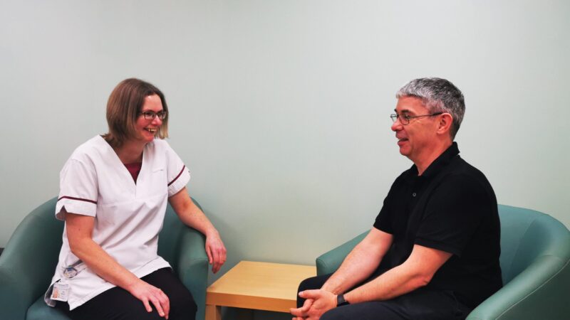 Review team member speaking to patient