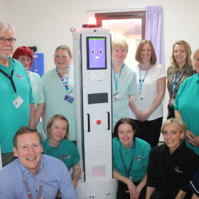 James Dunbar with the robot and representatives from Friends of the Friarage, Akara and the Friarage team