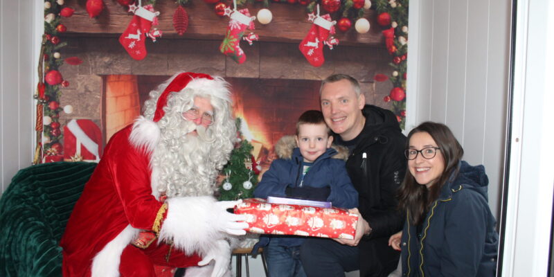 Santa in the Grotto with Andy, Debbie and Charlie Miller