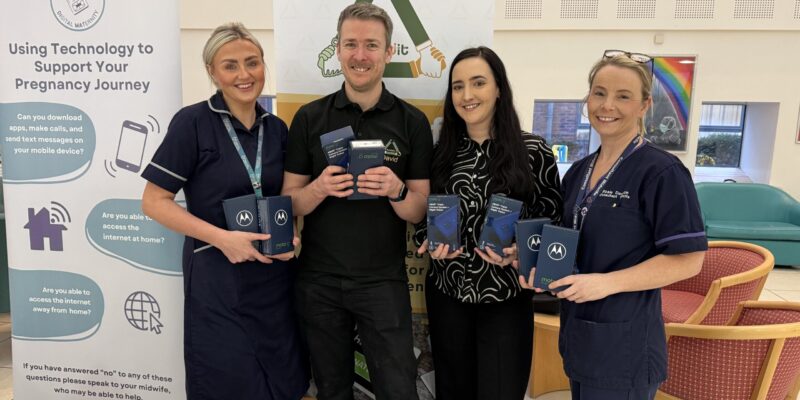 Members of staff holding electronic devices at the digital donation event