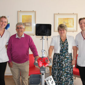 A group of people with a bladder scanner machine